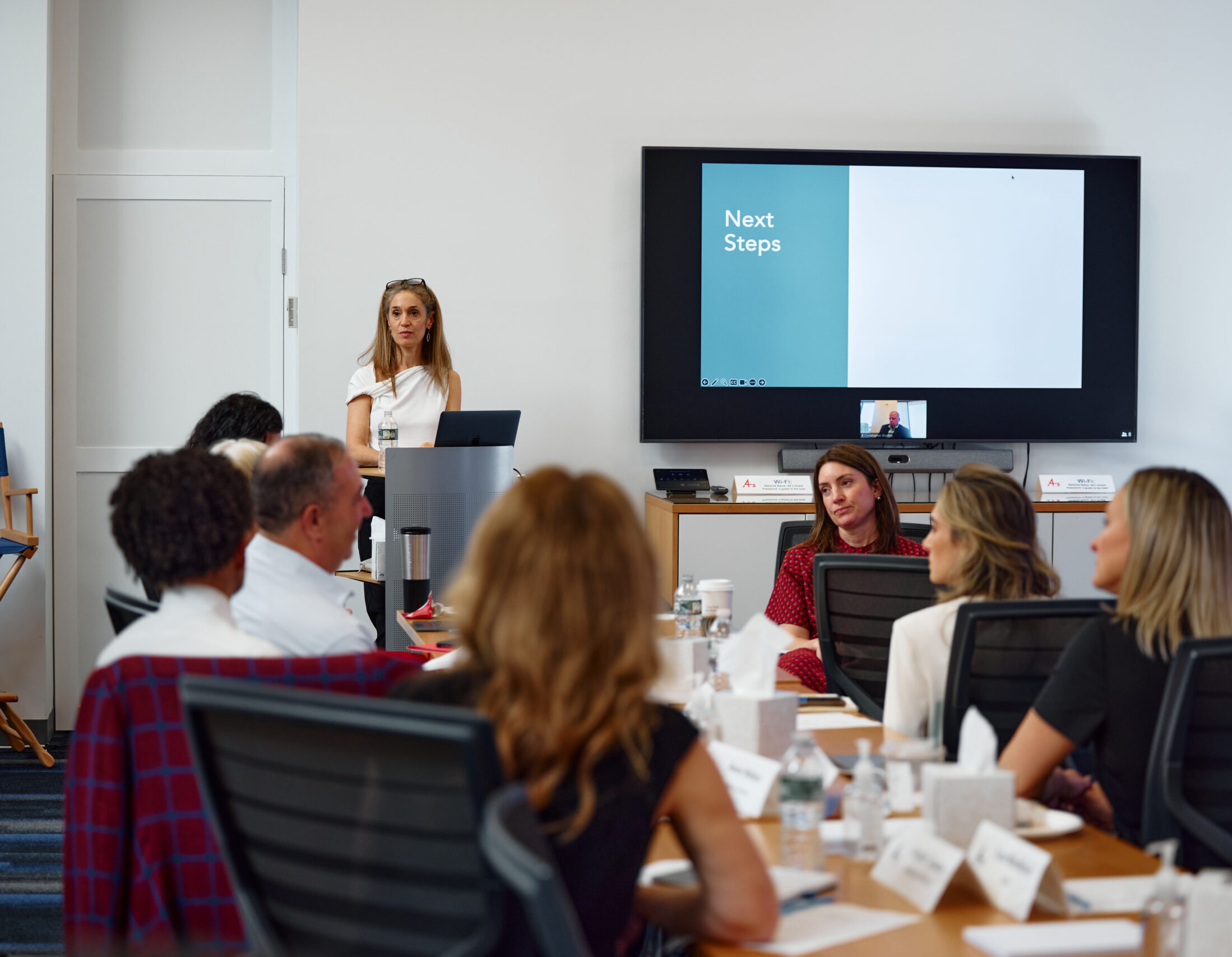 Woman giving a presentation in front of a mixed group of people