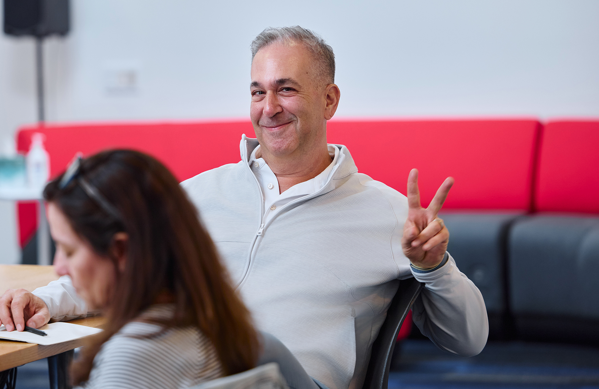 Person giving peace sign with hand