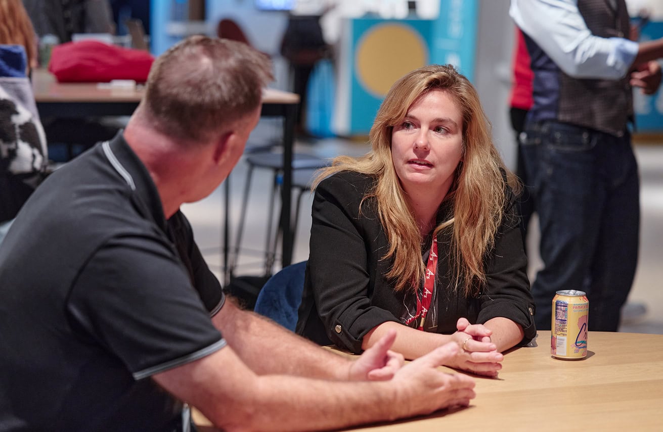 Man and woman chatting at event