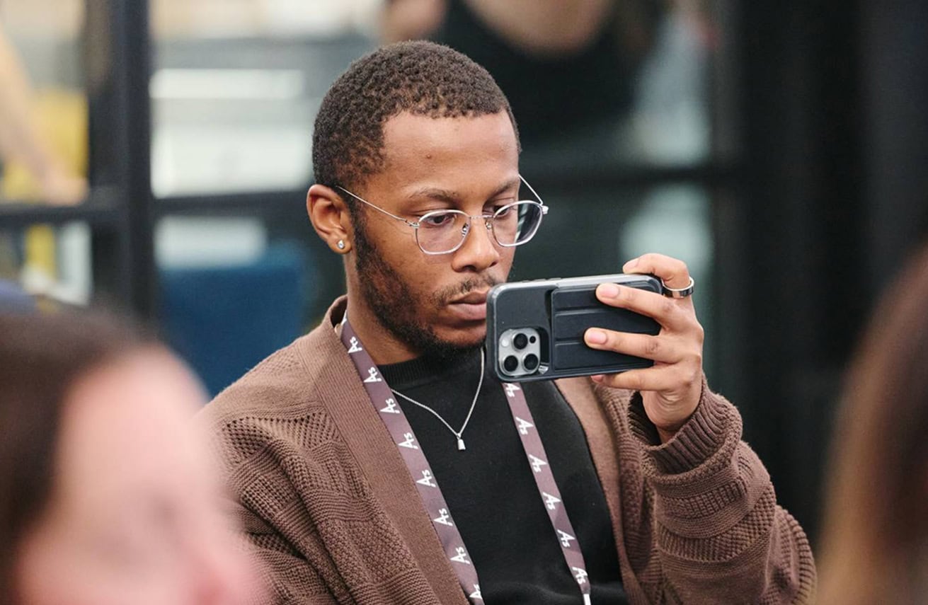 Man holding phone at event