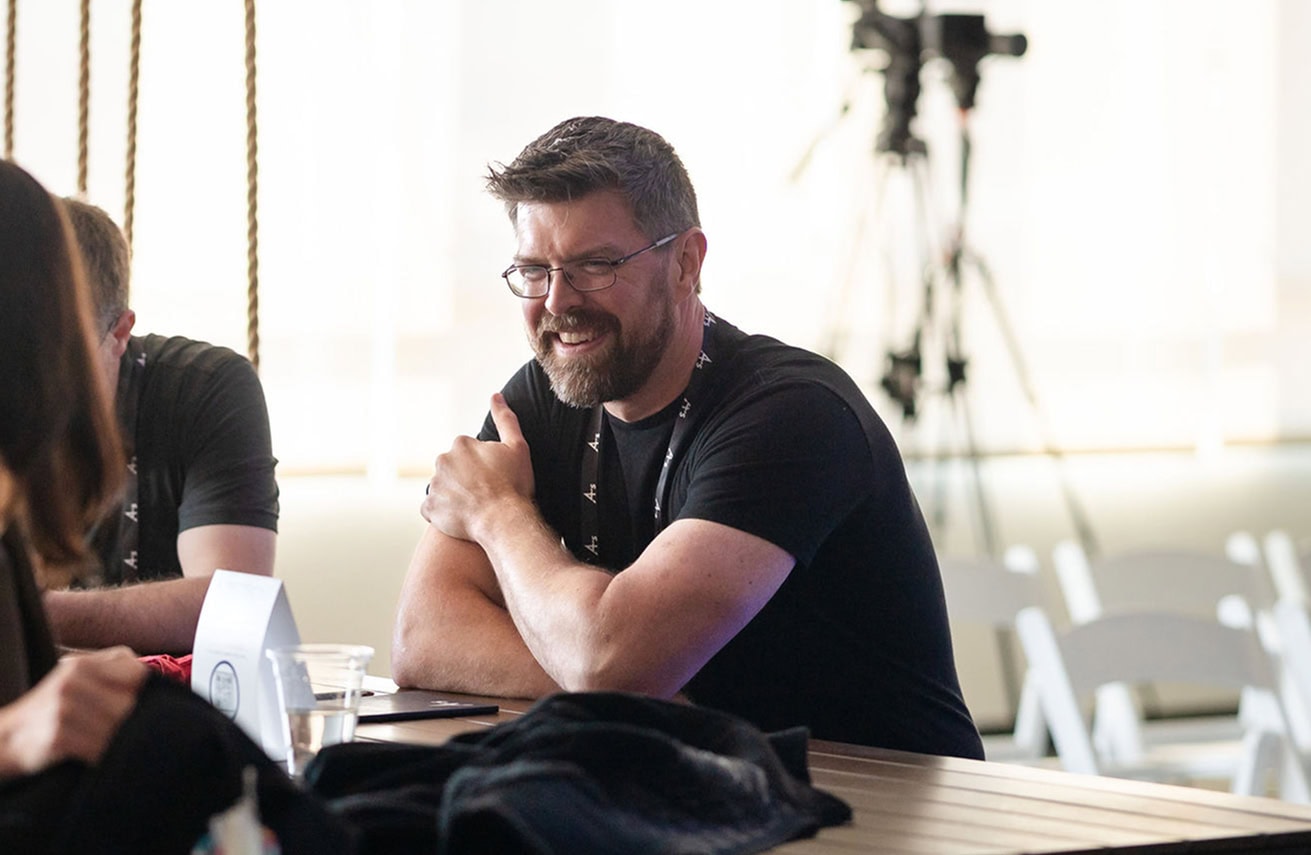Man sitting at table and smiling at event
