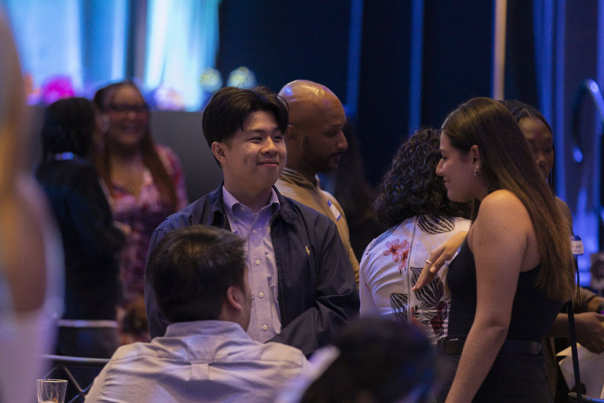 Group of young people chatting at event