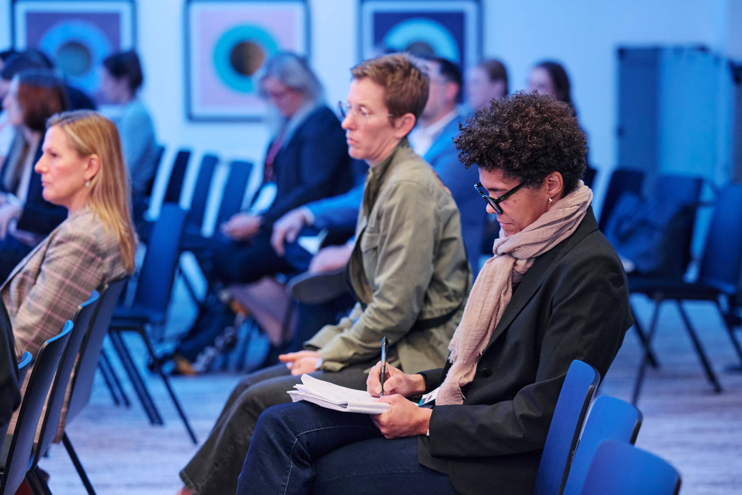 a person taking notes at a conference