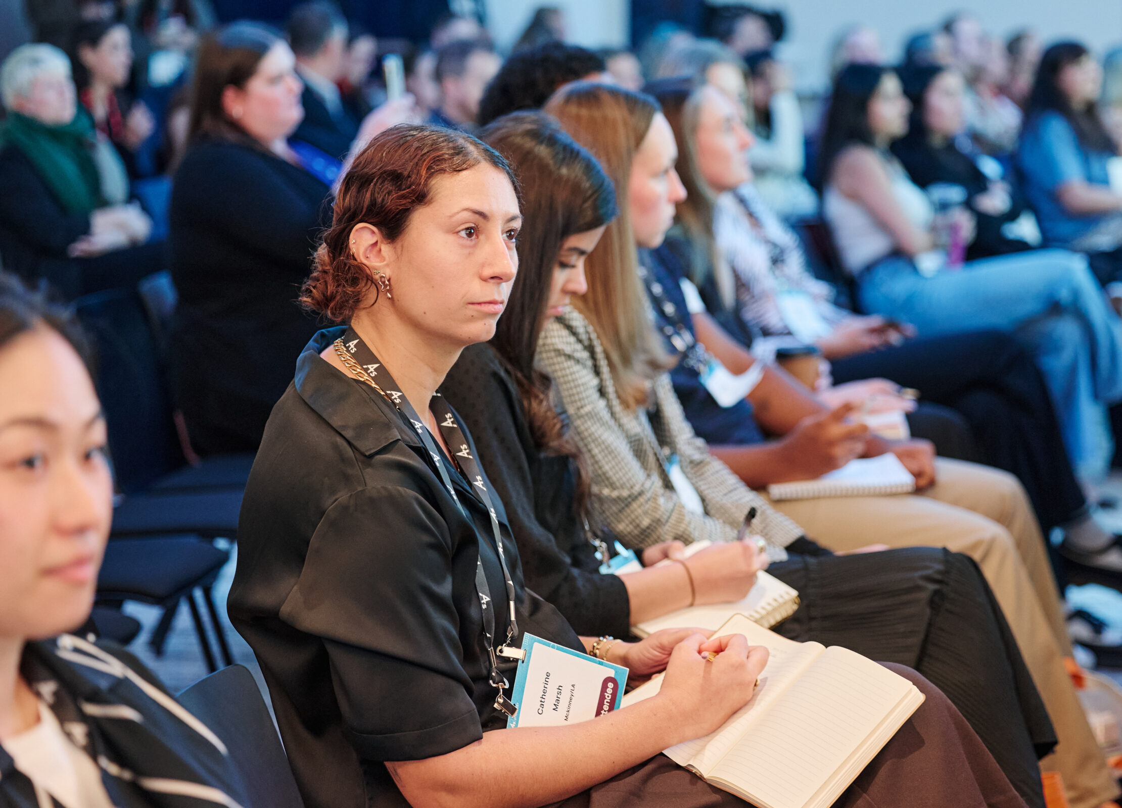woman taking notes at an event