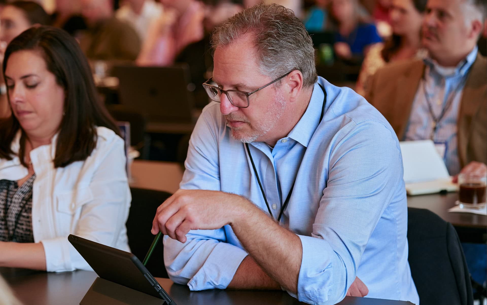 Man on tablet at event